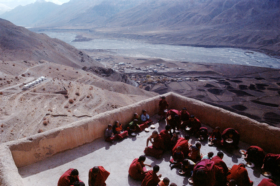 Ki Gompa, Spiti Valley, India 2014: Novice monks enjoying breakfast with a beautiful view. Spiti Valley is a remote, high-altitude slice of Tibet in India, mostly populated by subsistence farmers toiling under desert-like conditions. Ki Gompa is the most famous sight in a little-touristed location.