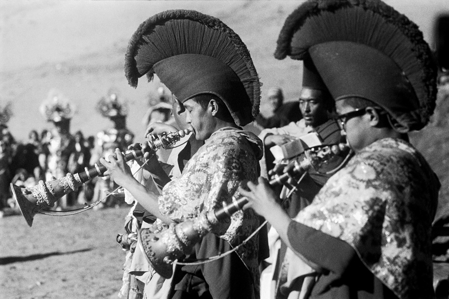 Khomic village, Spiti Valley, India 2014: Traditional cham dance performed by Tibetan Buddhist monks to bring blessings onto the community, featuring brightly-colored costumes and masks. The dance eventually moved from the temple to a field. Due to the high altitude, the dancers & musicians exhausted quickly.