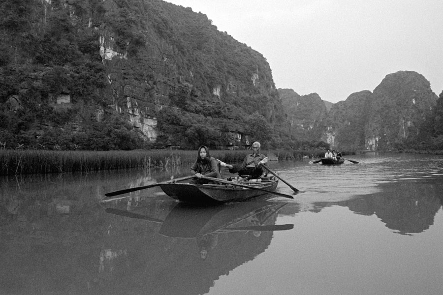 Tam Coc, Vietnam 2013: rowing canoes using feet is the common technique in this river region.