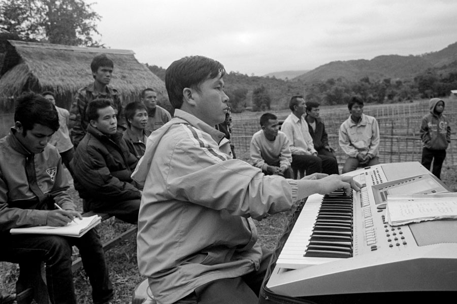 Muang Khan, Laos 2012: wedding musician and guests.