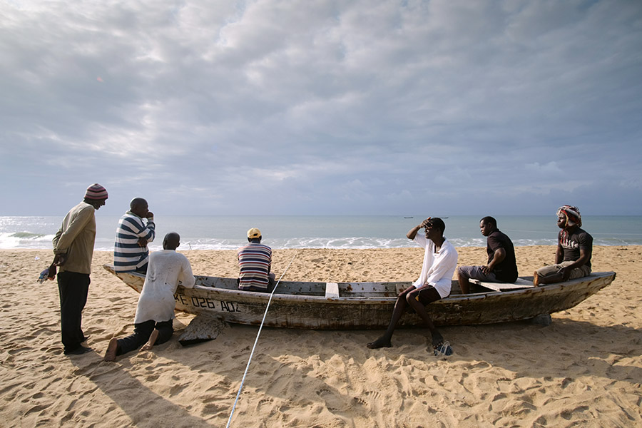 Keta, Ghana 2018: fishermen waiting for the waves to calm down before pulling in the net.